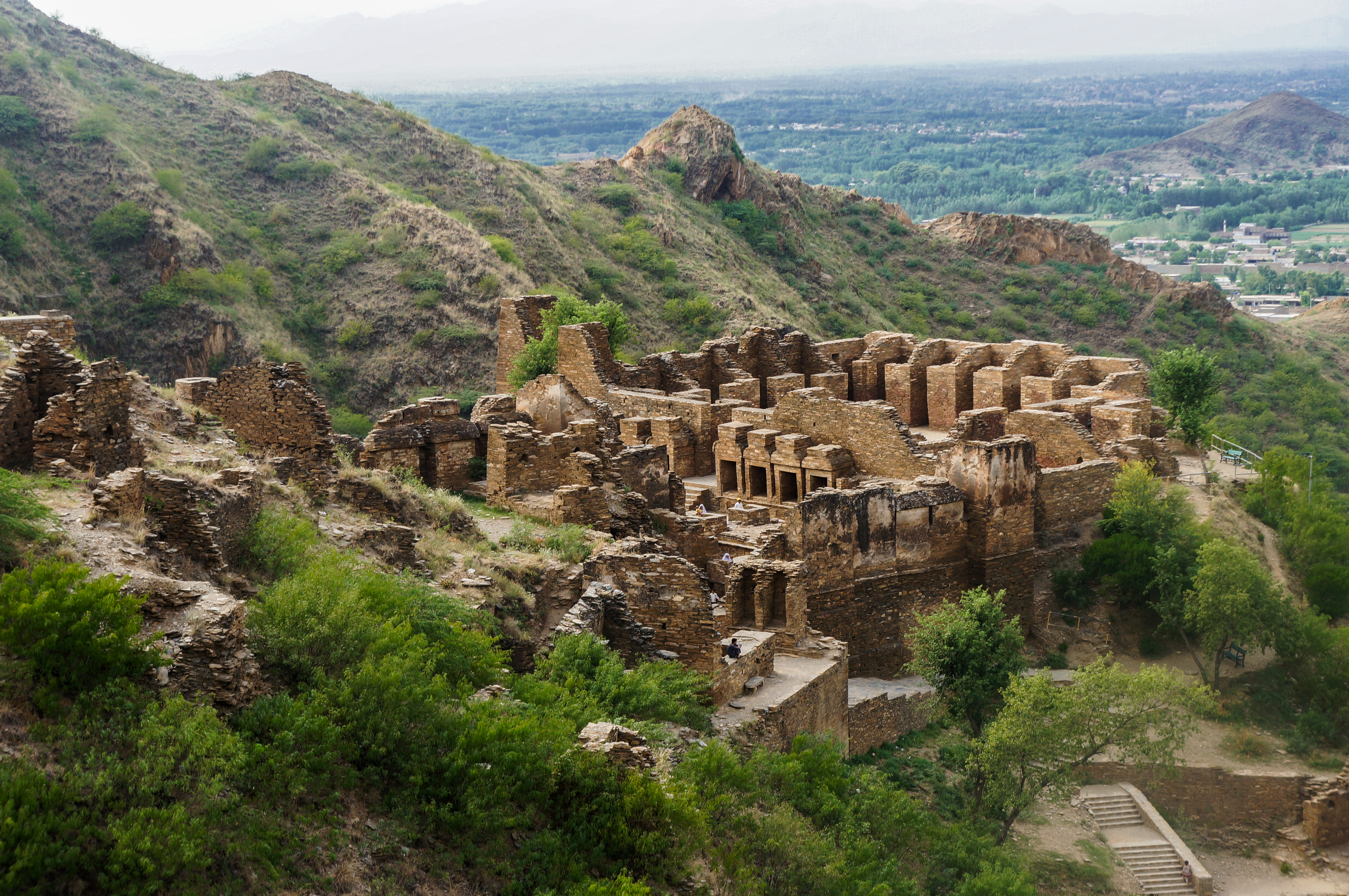 Ruins of a Buddhist stupa site from the Gandhara civilization under a cloudy sky in Northern Pakistan