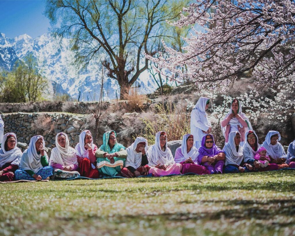 Guests among flowering trees in a Hunza orchard