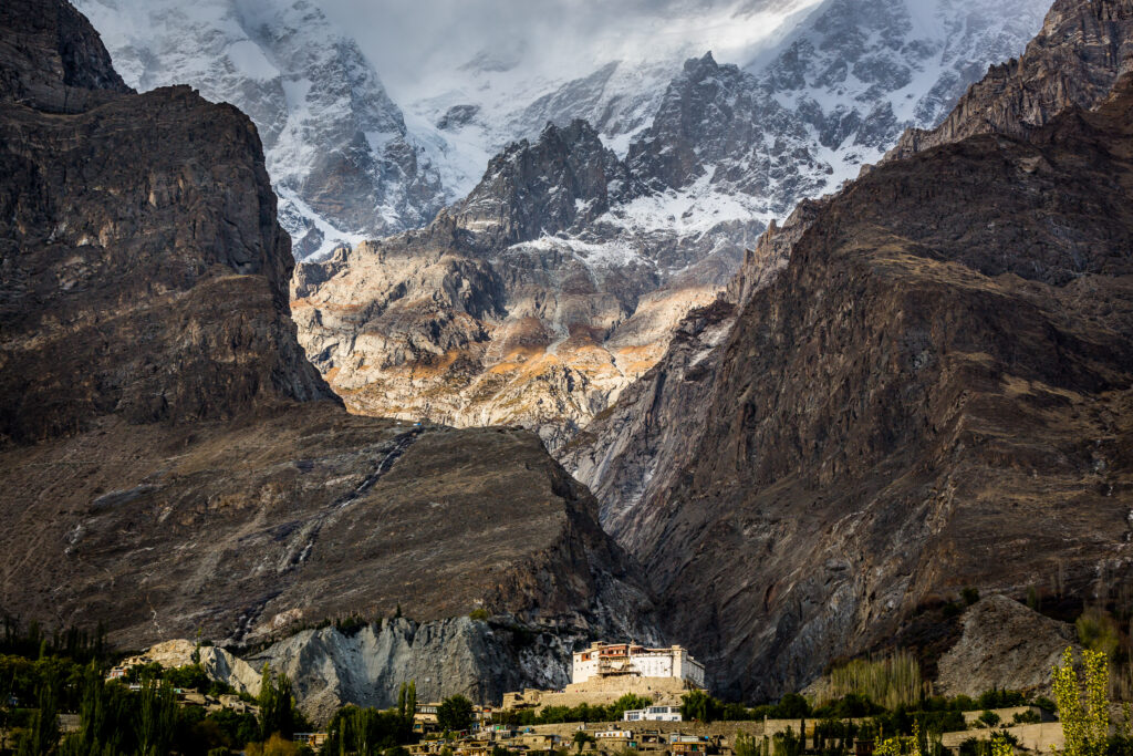 Snow-covered mountain above a valley settlement