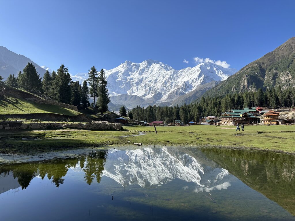 Mountain cabins and a reflecting pond at Fairy Meadows
