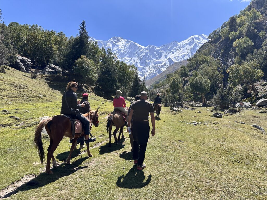 Horse riders with Nanga Parbat behind Fairy Meadows
