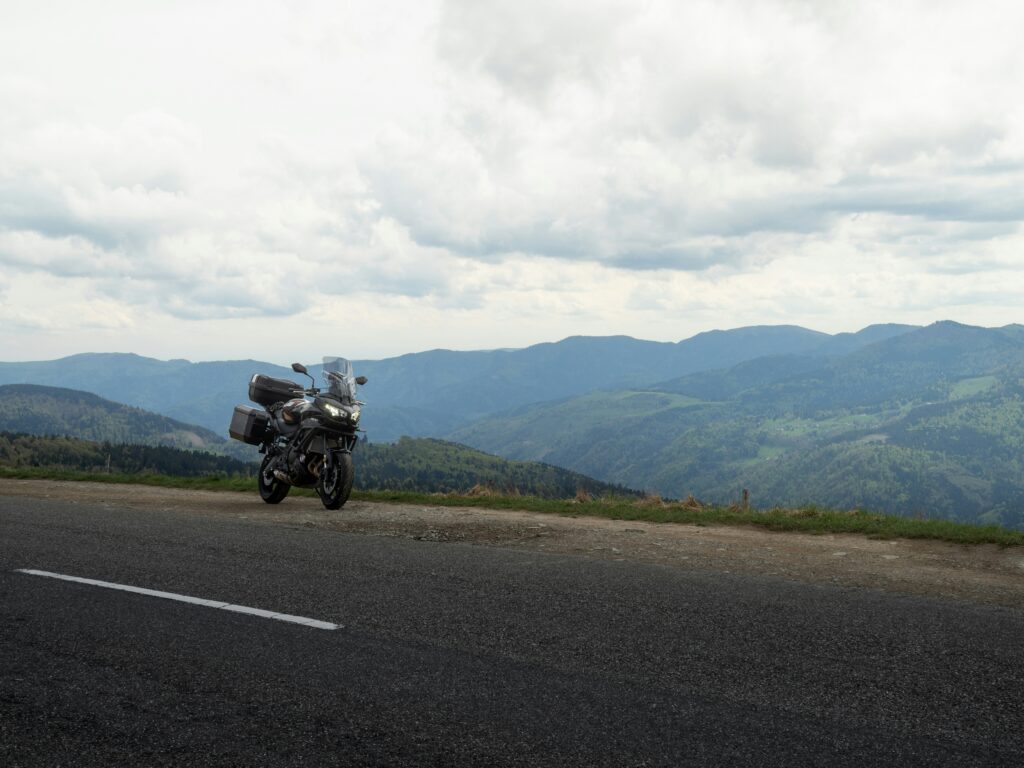 Motorbike overlooking a cloud-filled mountain valley