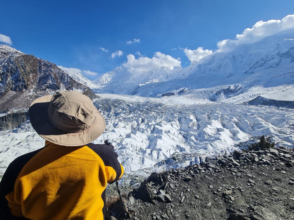 Hiker looking across a glacier valley