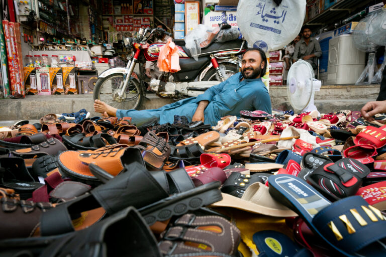 A footwear seller at his stall in Rawalpindi’s Raja Bazaar.