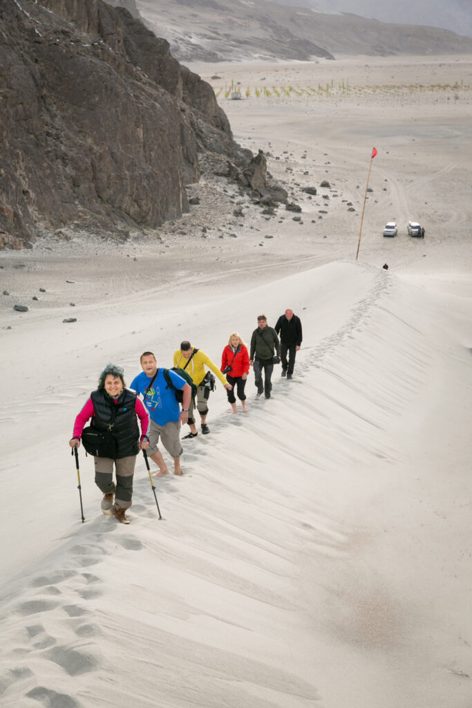 Guests walking across the sand dunes of Sarfaranga, near Skardu.