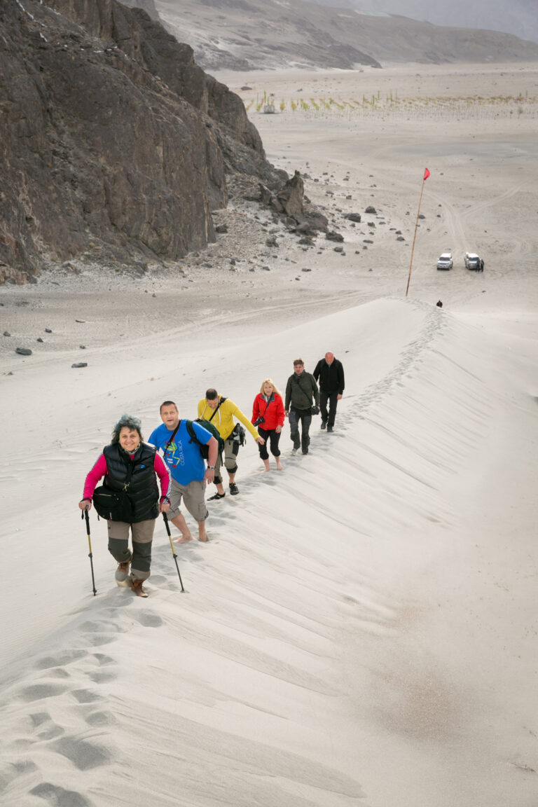 Guests walking across the sand dunes of Sarfaranga, near Skardu.