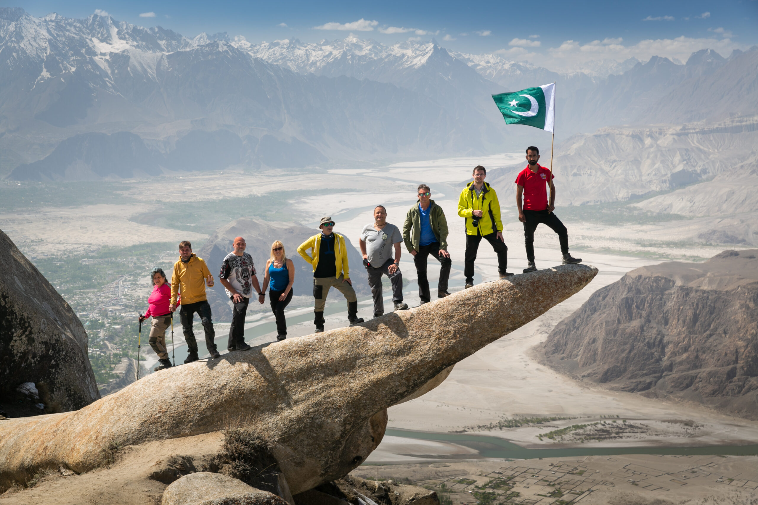 A group pauses on Masur Rock, with the Skardu valley stretching below.