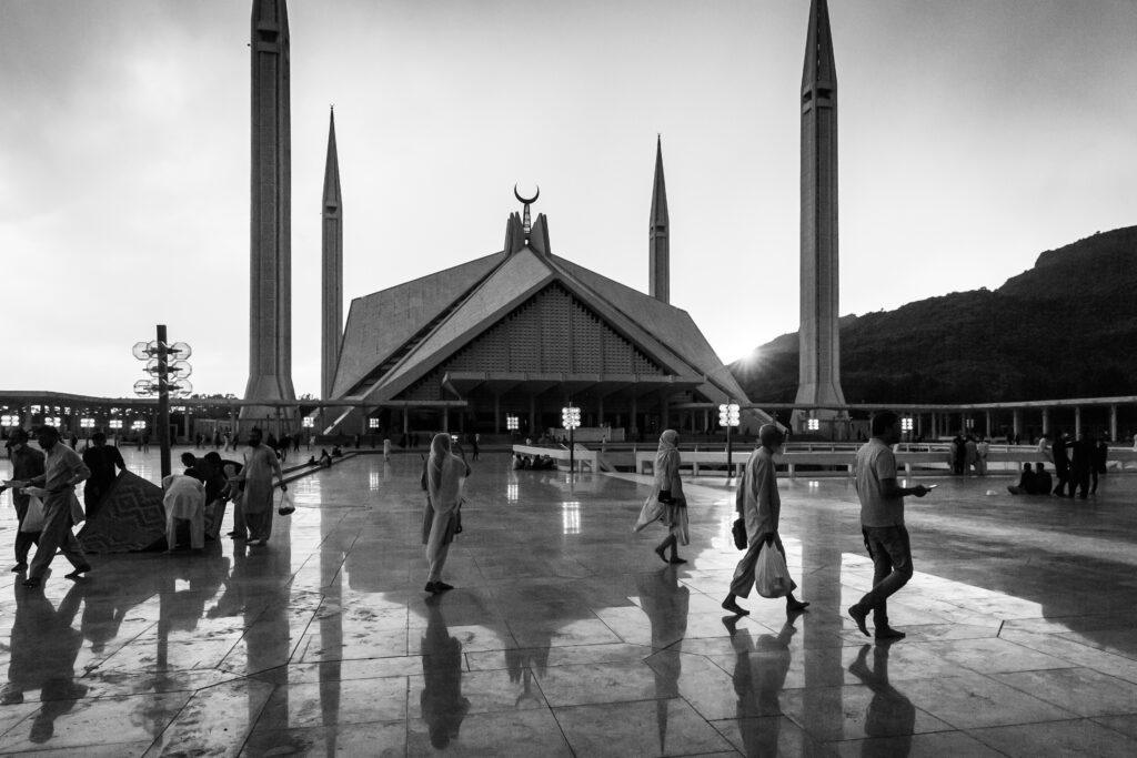 Visitors crossing the courtyard of Faisal Mosque in Islamabad.