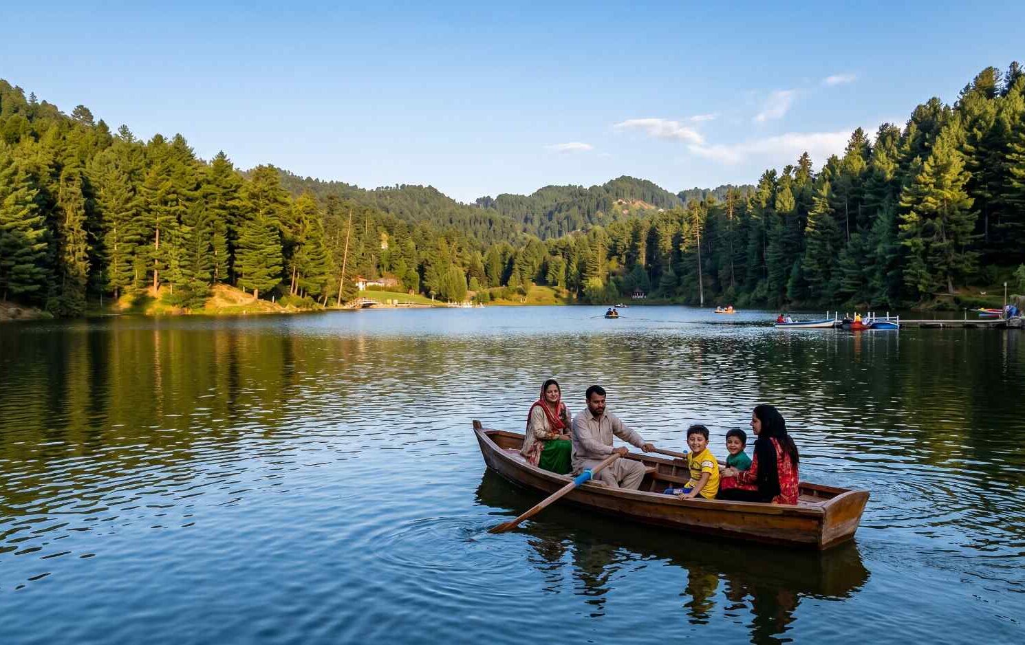 Banjosa Lake near Rawalakot Azad Kashmir Pakistan surrounded by dense pine forests with families boating on the calm water