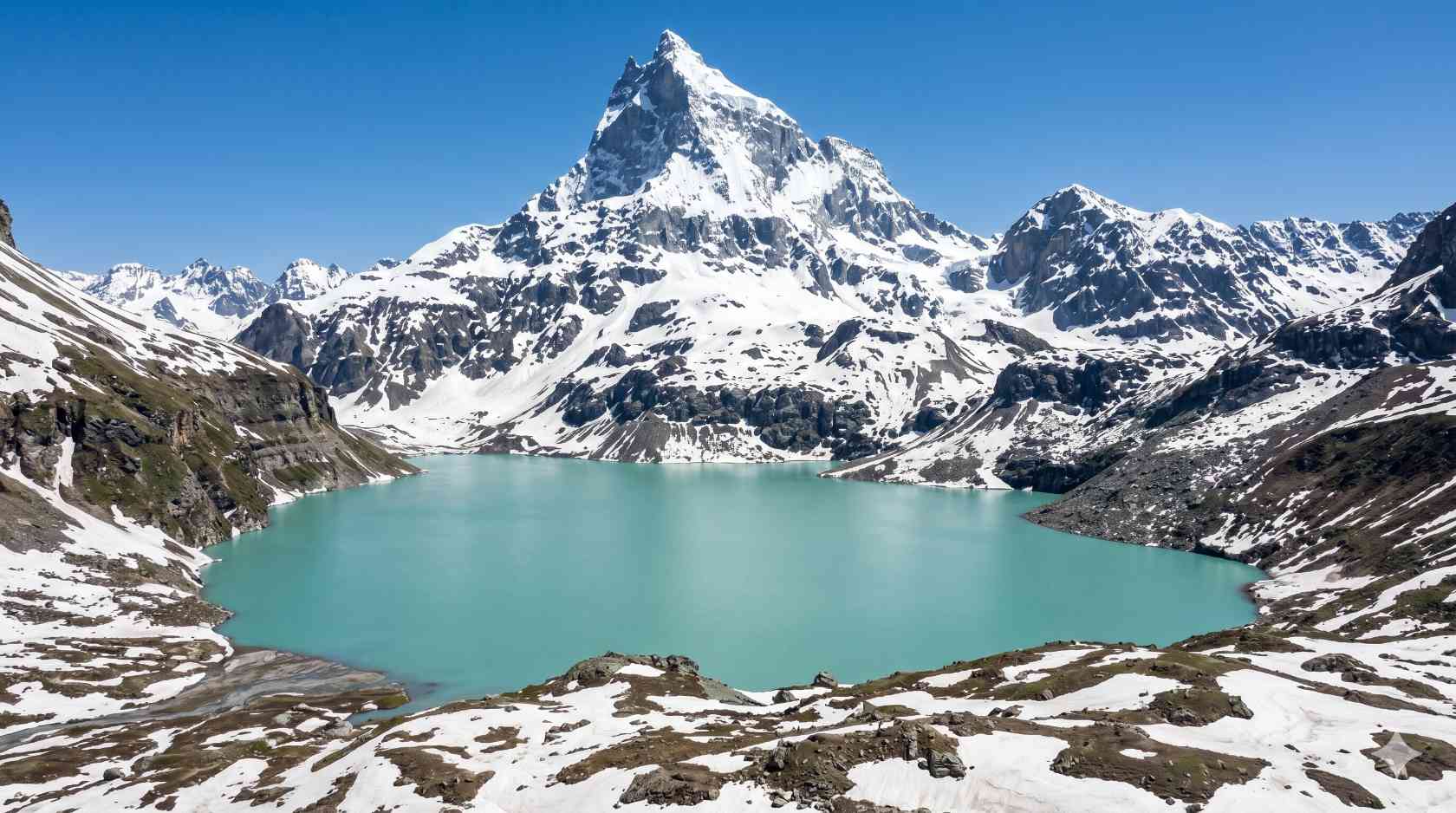 Chitta Katha Lake in Shounter Valley Azad Kashmir Pakistan with milky turquoise water and snow-covered Mount Hari Parbat behind