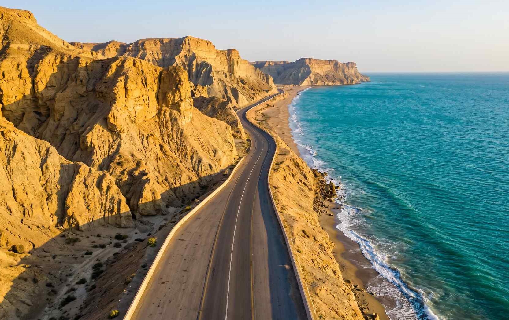 Makran Coastal Highway Balochistan Pakistan with dramatic golden cliffs, wild coastline and turquoise Arabian Sea