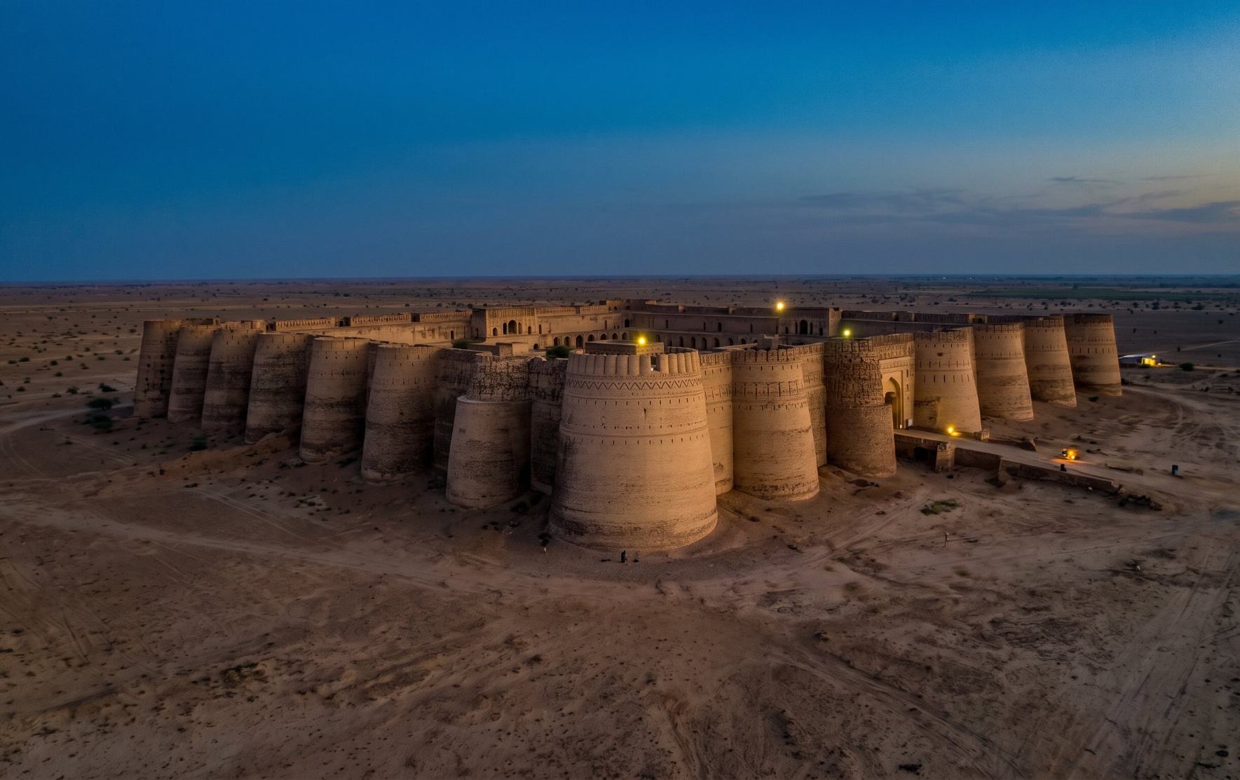 Derawar Fort in the Cholistan Desert Punjab Pakistan rising from the flat desert landscape at dusk with its 40 towers intact