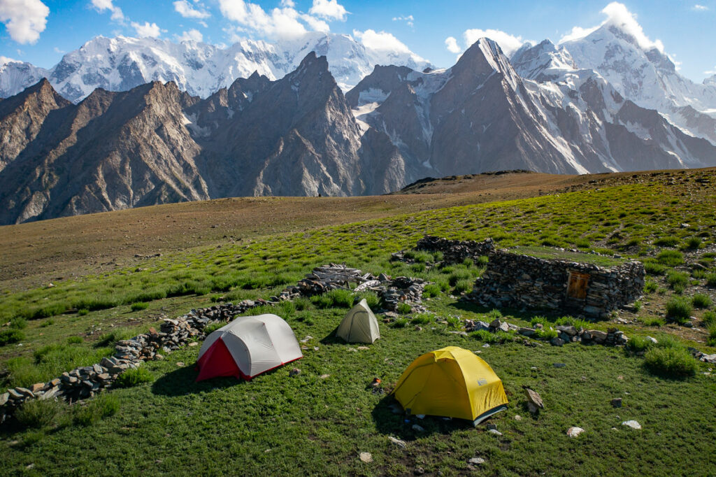 Tents beside a stone shepherd shelter on Patundas pasture
